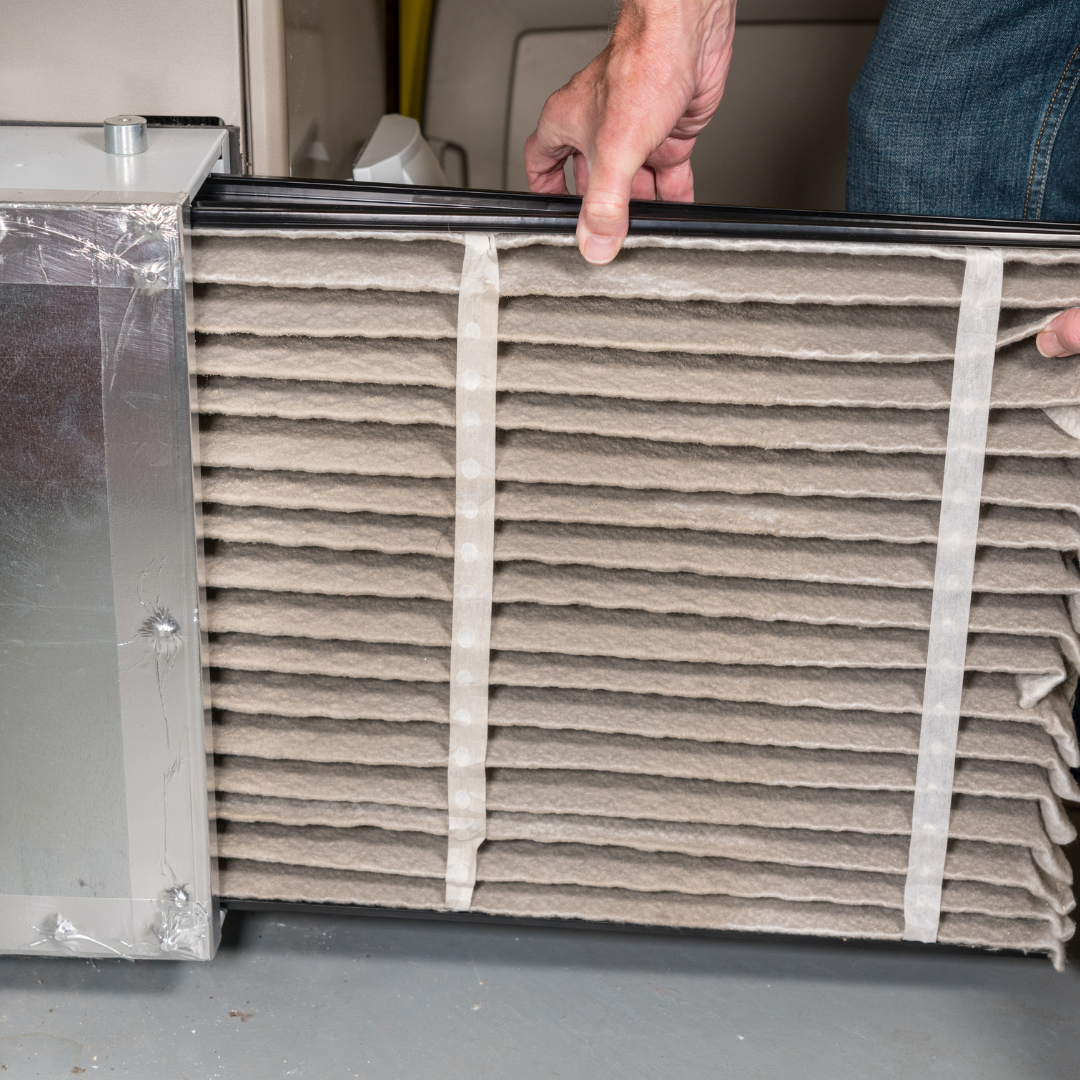 A furnace filter being replaced